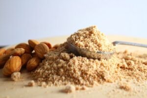 A close-up view of almond flour, showcasing its fine texture and light color, ideal for baking and cooking.